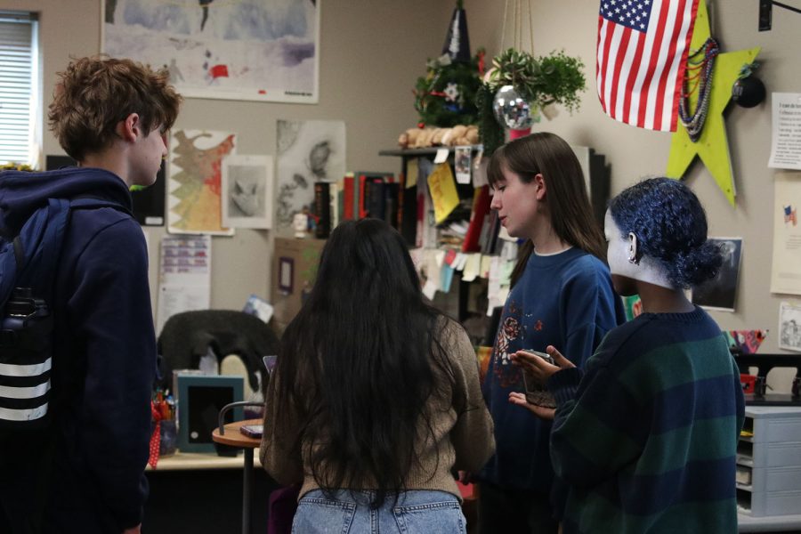 Co-president senior Sarah Johnston helps students interested in joining Model UN sign up for the GroupMe after the meeting Tuesday, Jan. 10. 