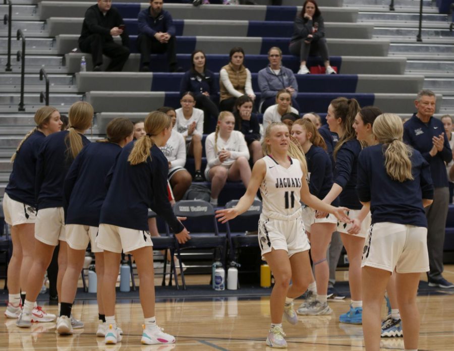 Senior Sophie Pringle high fives her teammates during the pregame lineup announcement. 
