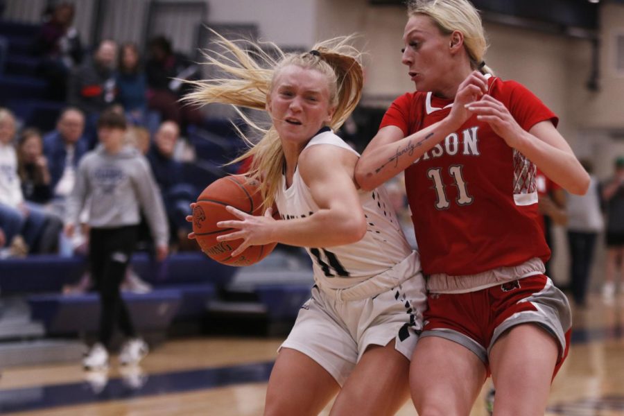 Senior Sophie Pringle takes a hit while driving to the basket. 