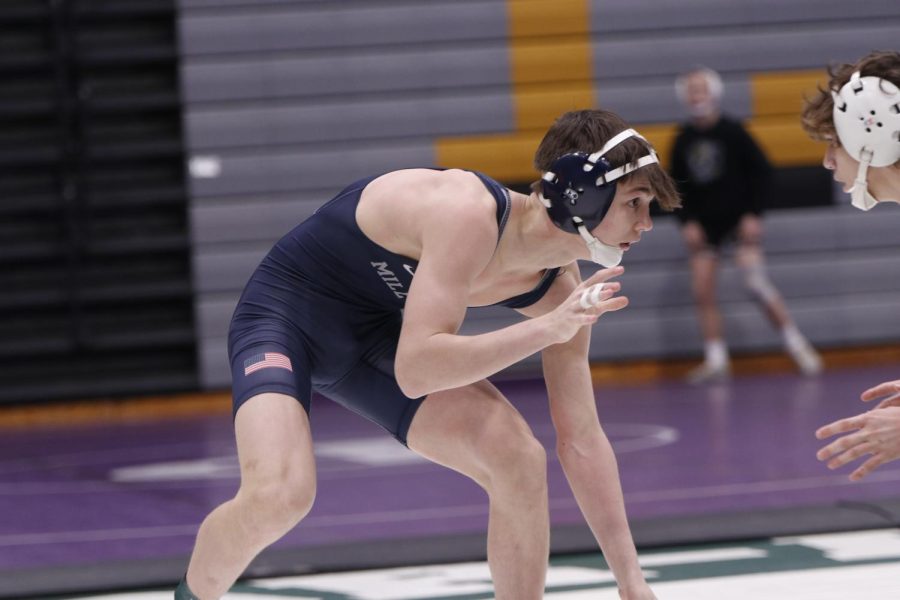 Leaning down, junior Dillon Cooper is about to strike at his opponent.
