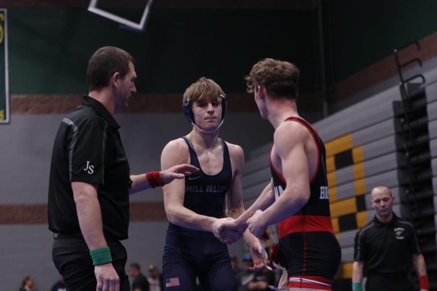 Winning his match and makes it to the semi finals, junior Colin McAlister shakes his opponent's hand. 