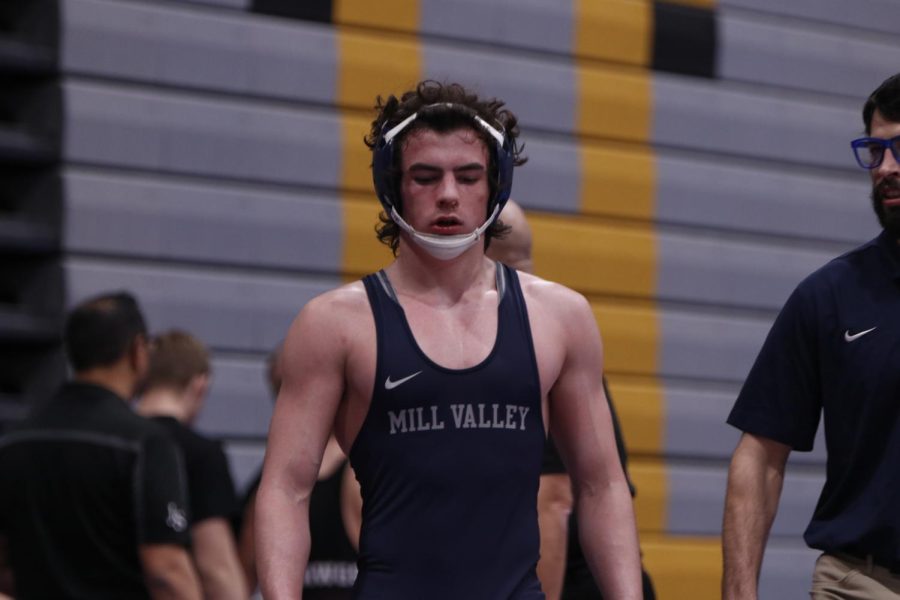 Junior Maddox Casella walks back to his opponent after taking a break with Coach Lazor.