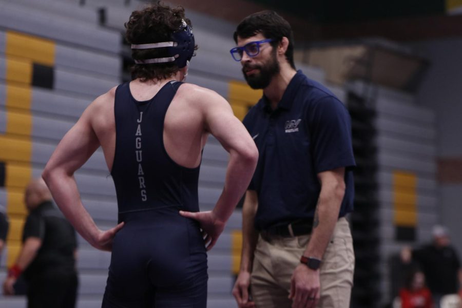 During a match, junior Maddox Casella takes advice from Coach Lazor.