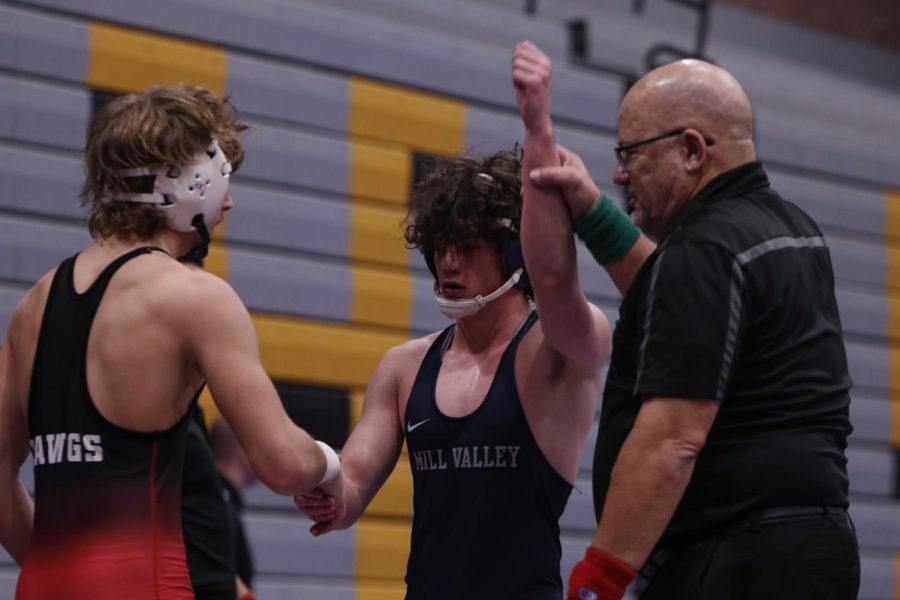Shaking his opponents hand, junior Maddox Casella wins his match.