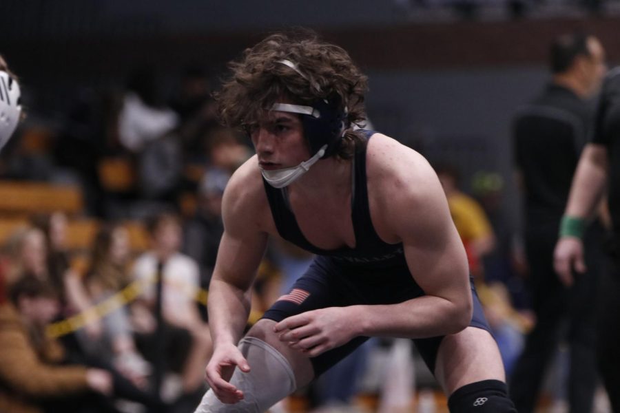 About to strike, junior Maddox Casella stares into his opponents eyes during his match.