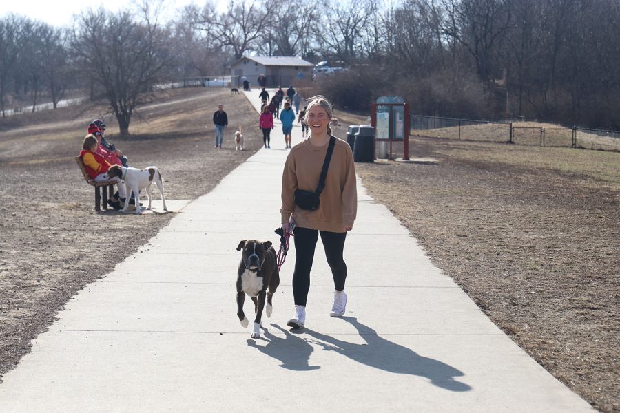 Walking with her dog, junior Jaiden Fisher enjoys some time outside at Shawnee Mission Dog Park Monday, Jan. 16. “I go to the dog park because it lets my dog run and be free while letting me get some fresh air,” Fisher said. “I like that you get to be outside and let your dog interact with other dogs.”