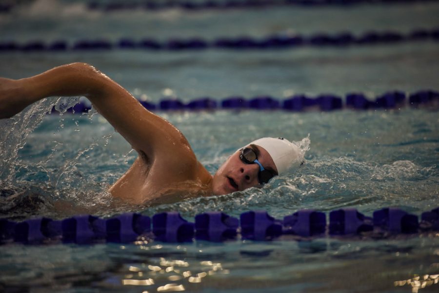 In lane four, sophomore Justice Bussell races to the finish line in the 100-yard freestyle 