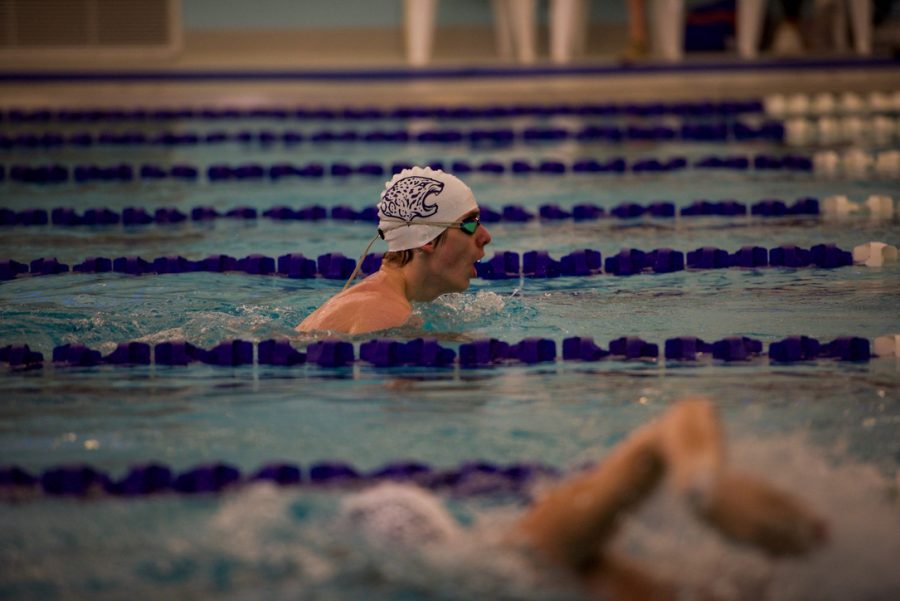 Sophomore Evan Wendler warms up before the 50-yard freestyle. 