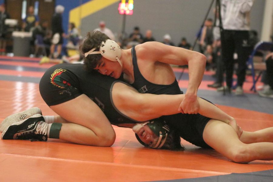 Senior Dylan Massey grabs his opponent by the arm while trying to take him to the floor.