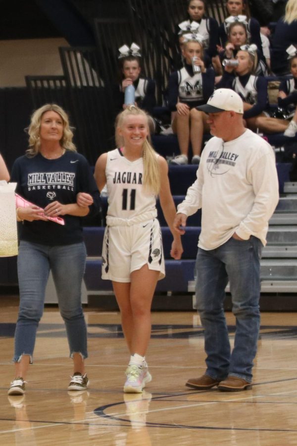 With a smile, basketball senior Sophie Pringle is recognized for senior night.