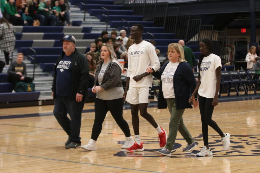 Beside his family, senior Nen Matlock is recognized as a basketball senior.