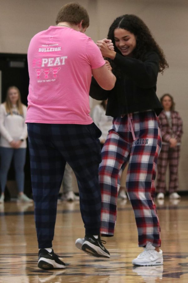 After being announced as candidates for Sweetheart court, seniors Jack Melvin and Olivia Page perform a handshake. 
