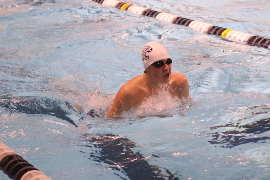 Sophomore Carson Reynolds comes up for a breath during the 100 meter breaststroke.