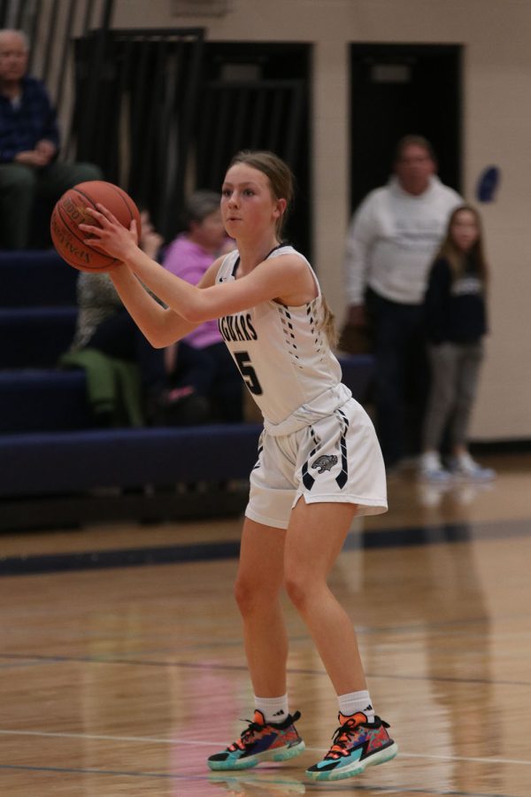 Sophomore Josie Benson looks around the court to pass to a teammate. 