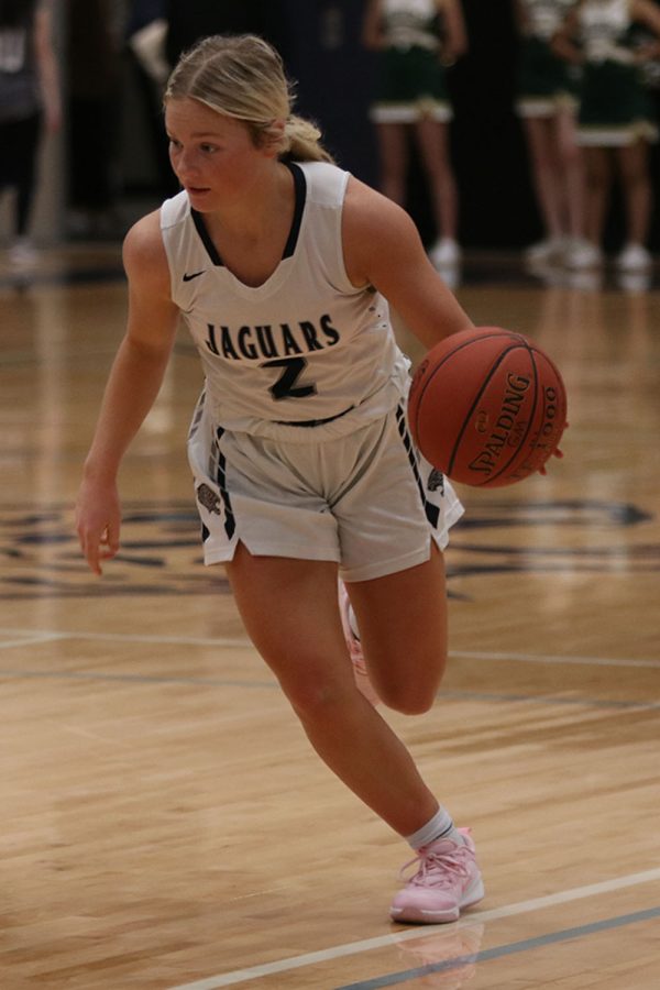 Ball in hand, junior Keira Franken dribbles the ball down the court. 