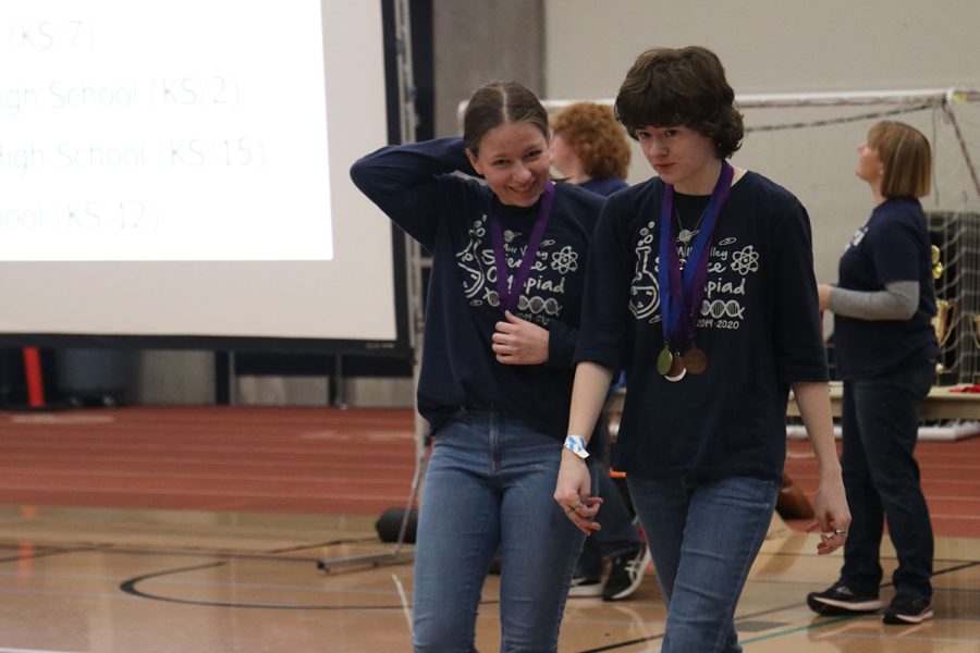 Seniors Madison Koester and Sydney Downey walk back to their team after claiming their sixth place award for Wifi Lab.