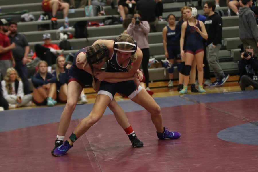 Standing strongly, junior Emily Summa prepares to bring down her opponent.