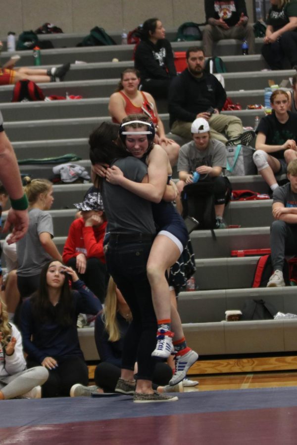 After winning her match to advance to the finals, sophomore Piper Wendler hugs coach Michelle McRay.