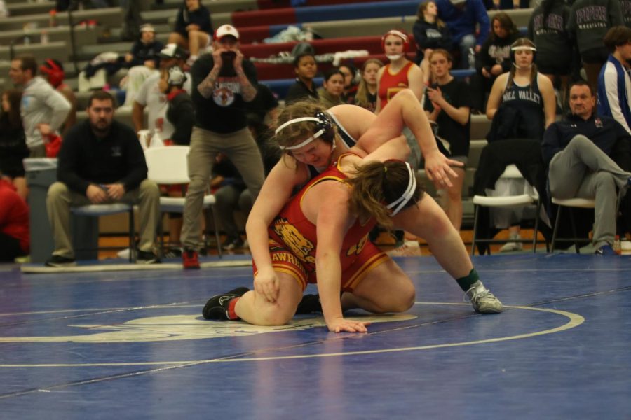 Holding her opponents arm, freshman Emma Lee attempts to flip her opponent over.