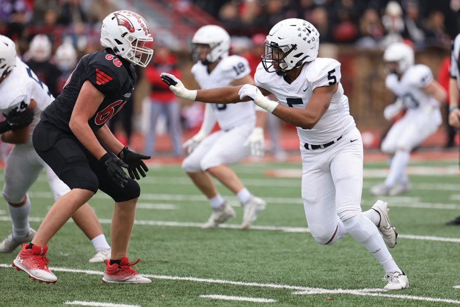 With his arms out, sophomore Jayden Woods goes to push back his opponent. 
