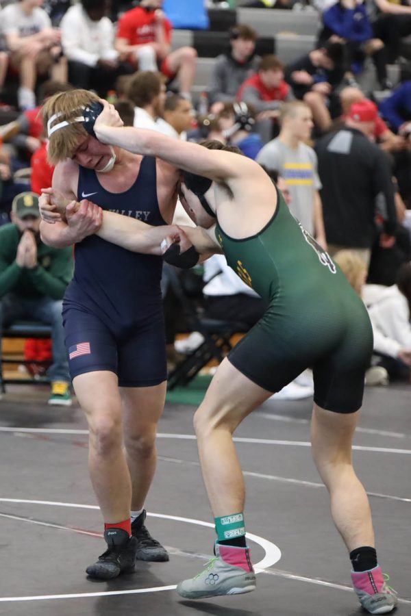 While being pushed back, junior Hayden Applebee attempts to bring his opponent down. 