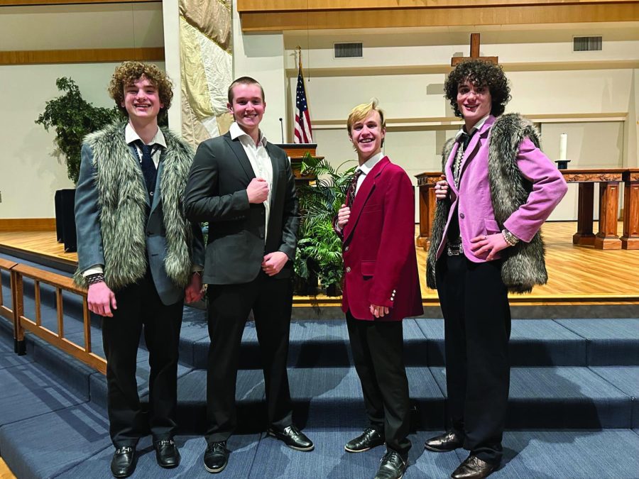 Posing for a photo, seniors Finn Campbell, Brody Shulda, Carter Harvey and Brayden Heath after their Harmony Explosion performance.