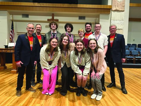 Seniors Finn Campbell, Brody Shulda, Carter Harvey, Brayden Heath and Asa Esparza and juniors Grace Cormany, Sarah Coleman and McKinley Graves pose with the Harmony explosion executives after receiving their medals. 
