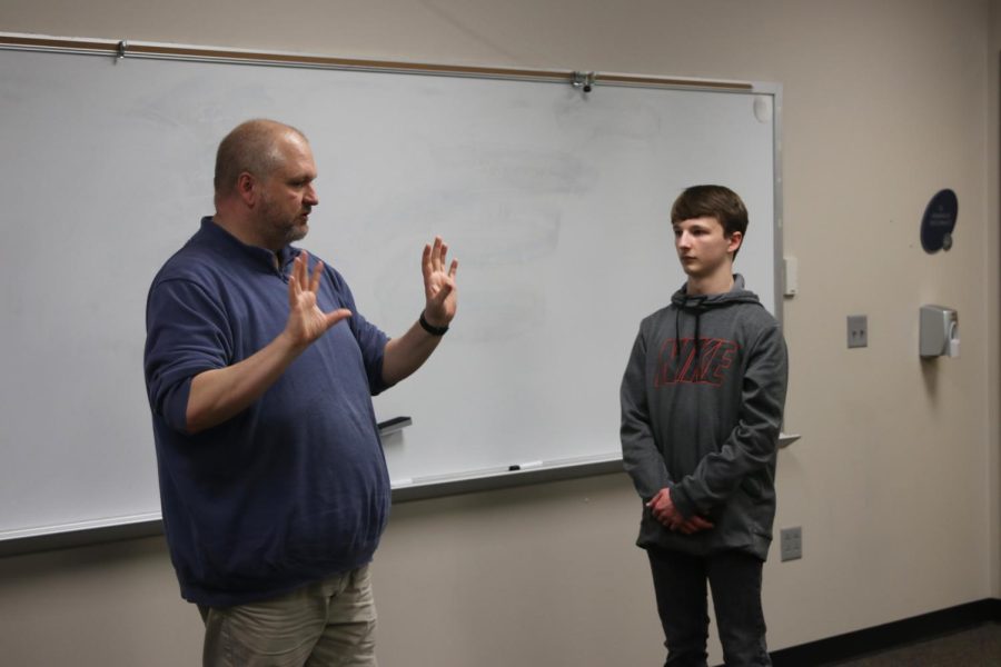 During class, freshman Drew Cormany takes advice from forensics coach Shawn Rafferty for their upcoming weekend tournament. "[I'm looking forward to] just seeing how I would improve my piece and see how far I can get." Cormany said. 