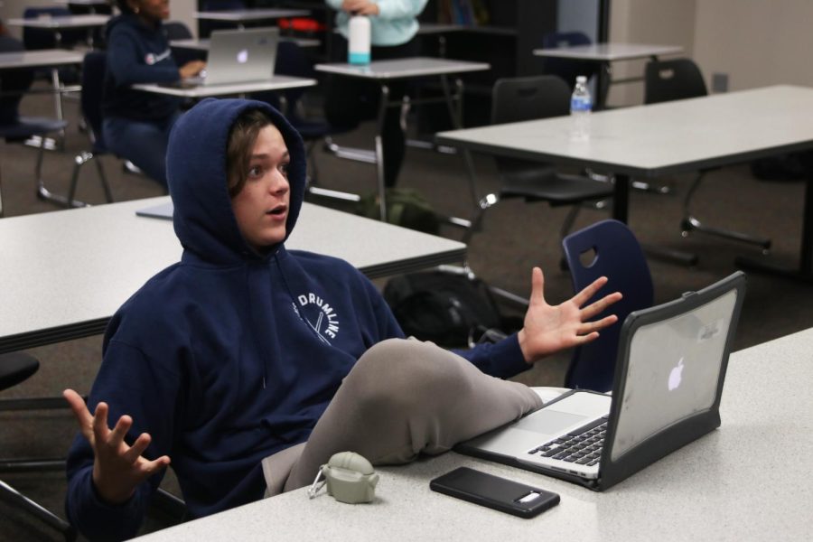 Sophomore Sawyer Clark gives advice to his teammates after their performance for their upcoming Olathe Northwest tournament. 