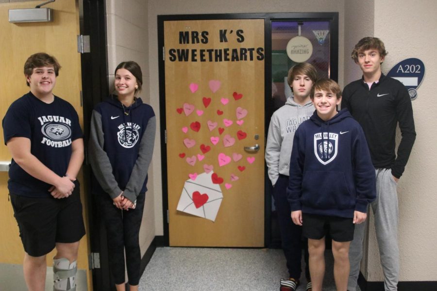 Sophomores Hank Danielson, Emmie Chezem, Zach Chesser, Carter Coup and Carter Cline pose in front of their finished decorated door.