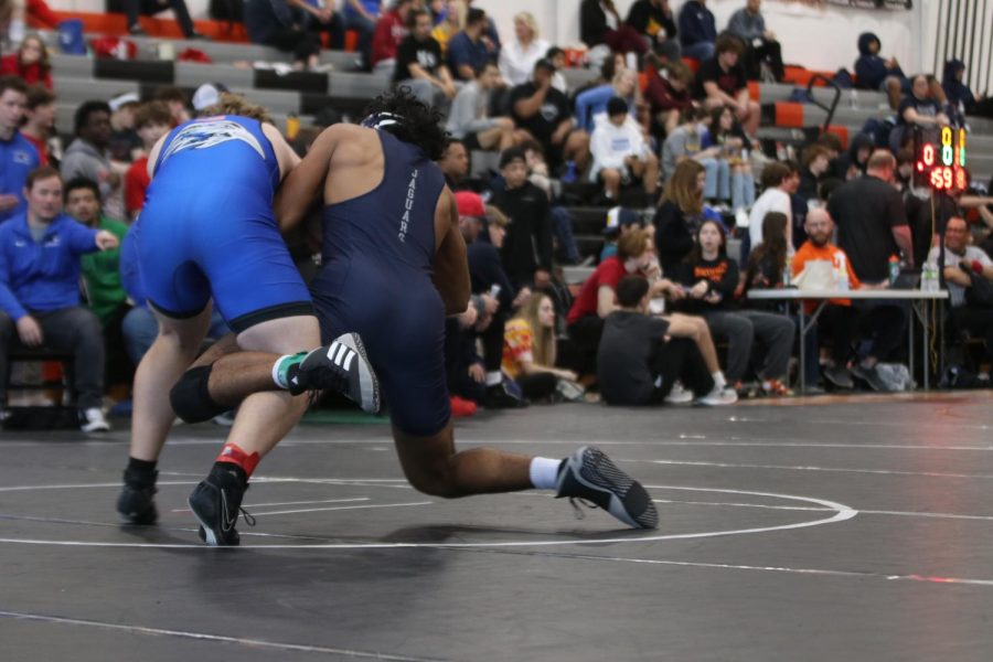 Wrapping his leg around his opponents, sophomore Jayden Woods attempts to take his opponent to the ground.