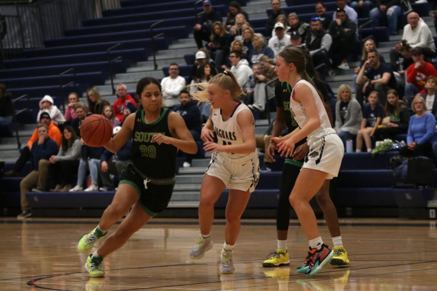 Running after an opponent, senior Sophie Pringle and sophomore Josie Benson run down the court.