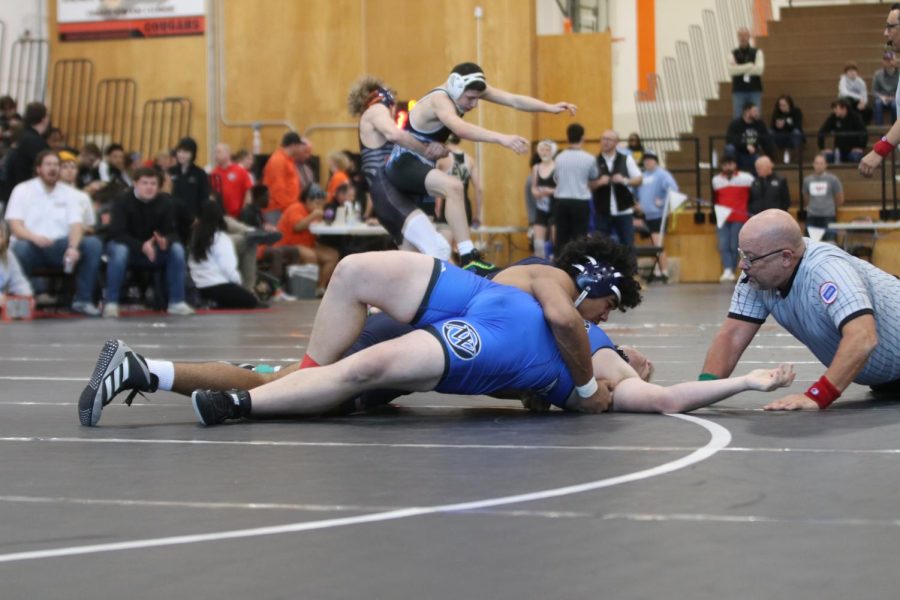 Sophomore Jayden Woods attempts to pin his opponent.