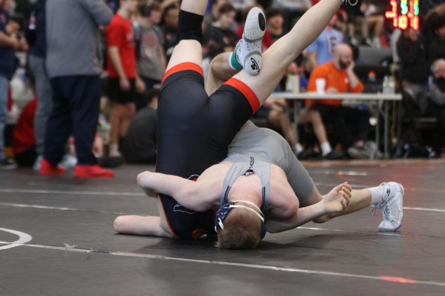Senior Sam Imes throws his opponent over onto his back.