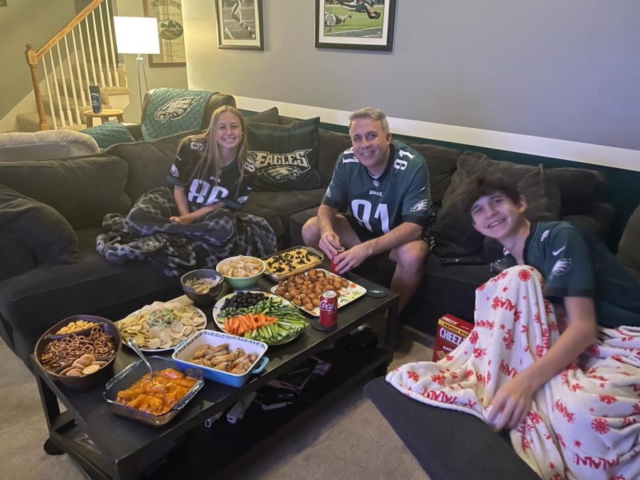 Like many other families watching the super bowl, sophomore Maggie Wieland and her family pose by their array of snacks to eat during the Super Bowl game.