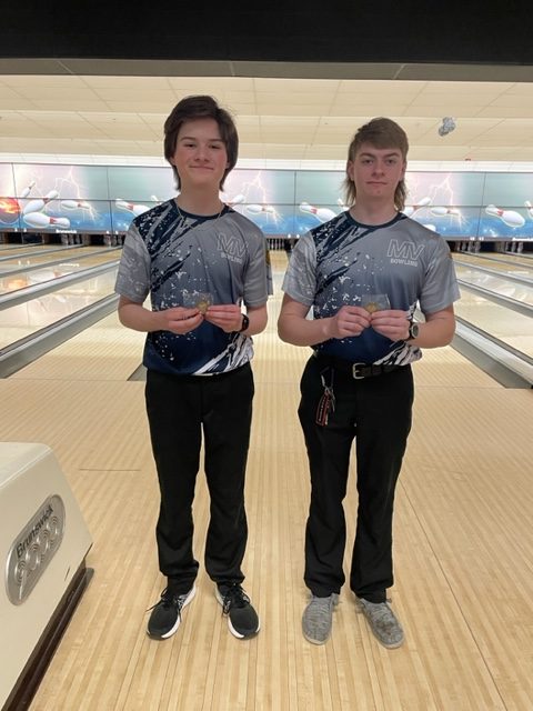 Junior Ethan Diehl and senior Nolan FitzSimmons smile after their second and third place finish at regionals, where they qualified for state. 