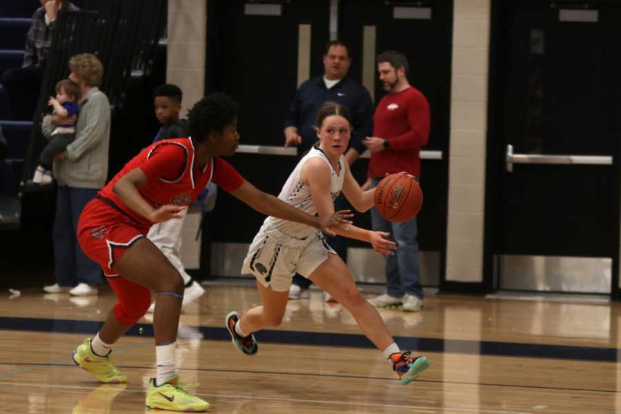 Finding the hoop, sophomore Josie Benson runs down the court.