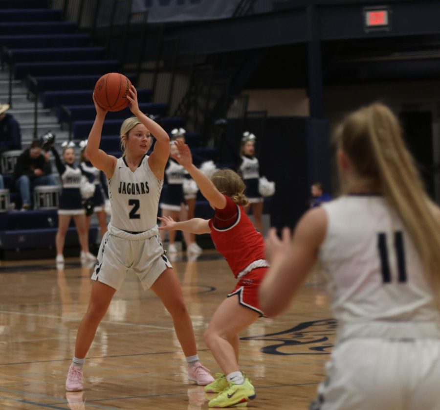 Looking across the court, junior Keira Franken finds a teammate to pass the ball to.
