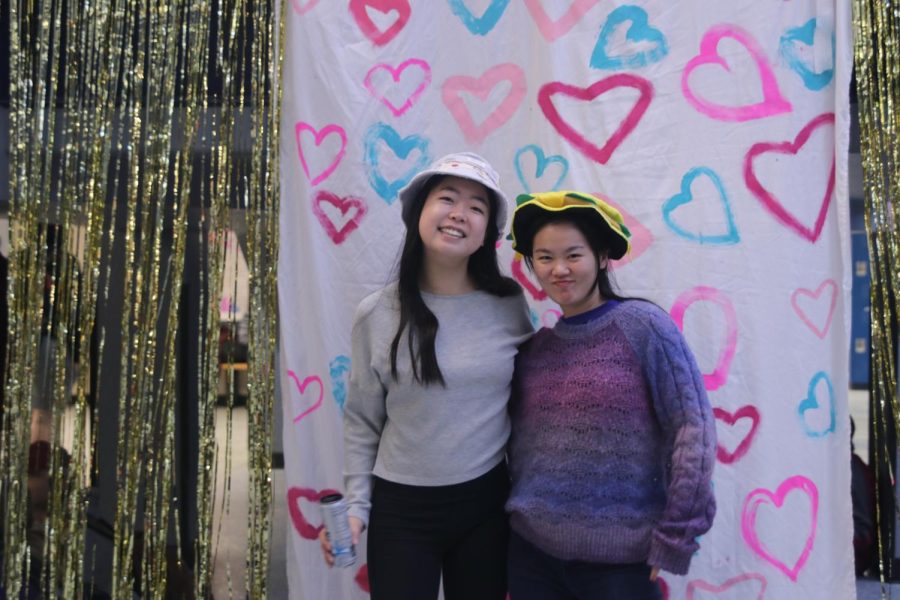 Smiling at the camera, seniors Ally Sul and Sophia Chang show off their hats.