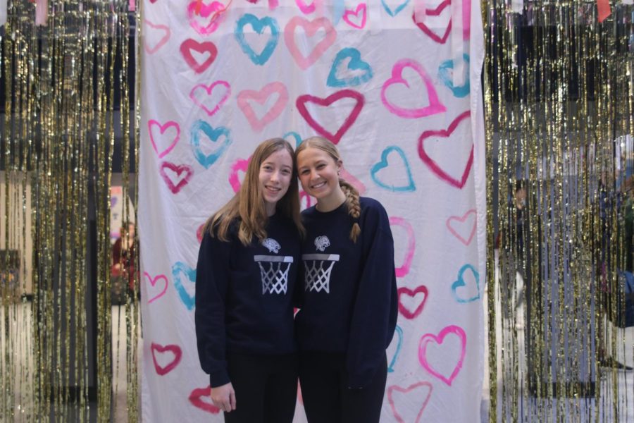 Arms around each other, sophomores Callie Cahoy and Maggie Weiland show off their best spirit wear.