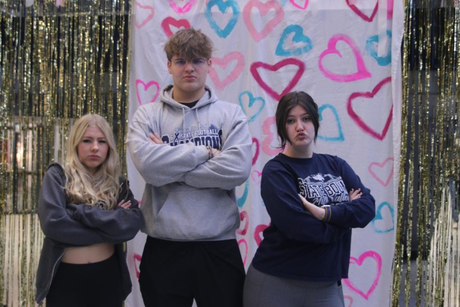 Arms crossed, junior Violet Hentges, Blake Powers and senior Reece Moulthrop pose for a picture.