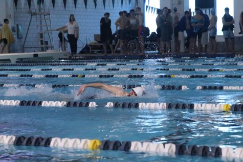 Taking a breath, junior Andre Arnold swims down the lane. 