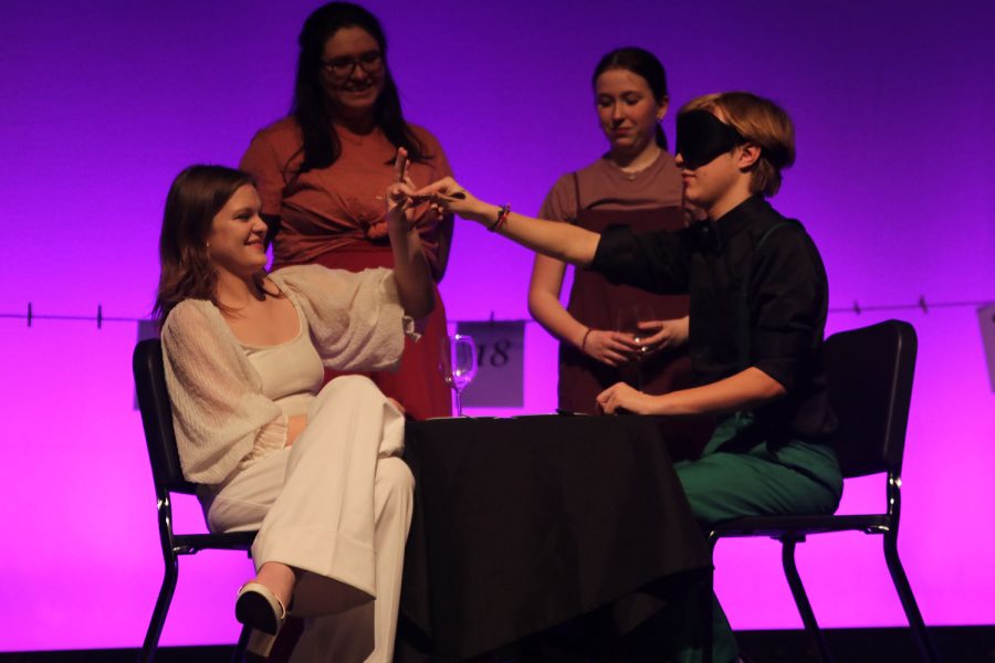 Sharing the fork at a ‘blind a date’ junior Caroline Alley and senior Carter Harvey perform that numbered play. 
