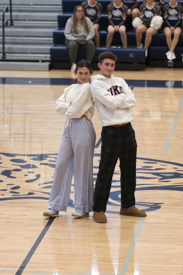 Back to back, seniors Lauren Aycock and Dylan Ashford stand after their Sweetheart candidate handshake. 