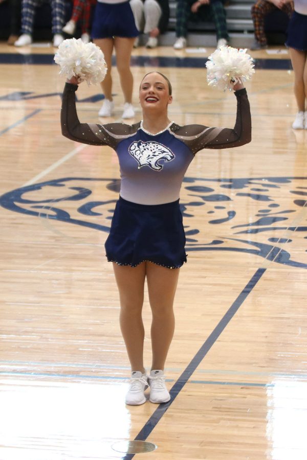 Hands up, junior Trinity Baker poses during the Silver Stars dance.