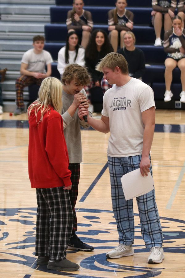During the Finish the Lyric game, junior Preston Fischer holds the microphone to junior Brady Mason. 