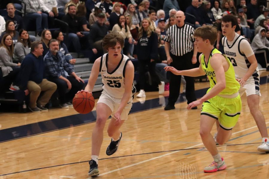 Sophomore Carter Kaifes dribbles towards the net around a blocker. 