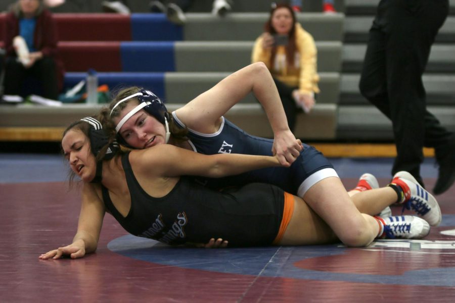 Focused, sophomore Piper Wendler pins her opponent down.