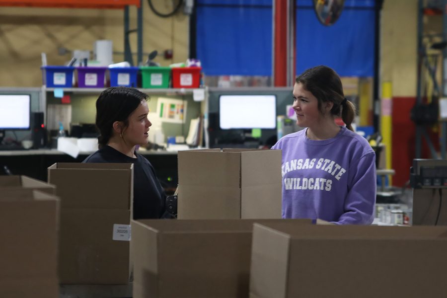 Sophomore Brynn Shideler and freshman Annie Newell talk while volunteering together at Harvesters Saturday, Feb. 25.  For more information on how to volunteer at Harvesters visit www.harvesters.org.