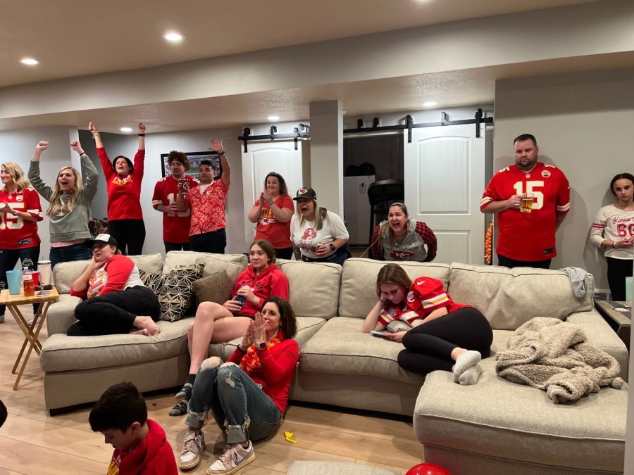 Anticipating the game, junior Peyton Zenger, her family and friends look at the TV.